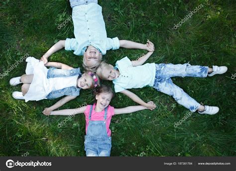 Children laying grass Stock Photo by ©ALotOfPeople 187381784