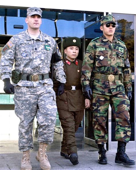 Repatriated North Korean soldier walking in between an American (1st ...