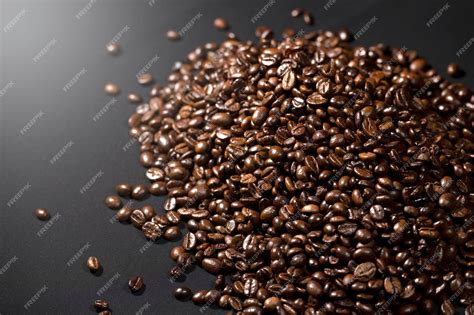 Premium Photo | Closeup view of coffee beans on a black background