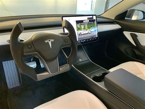 the interior of a car with an electronic device in the center and steering wheel view
