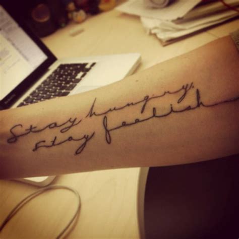 Forearm tattoo saying “Stay Hungry, stay foolish”