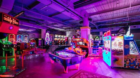 a room filled with arcade machines and neon lights