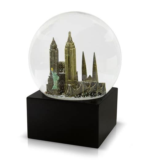 a snow globe with a city in it on a black stand against a white background