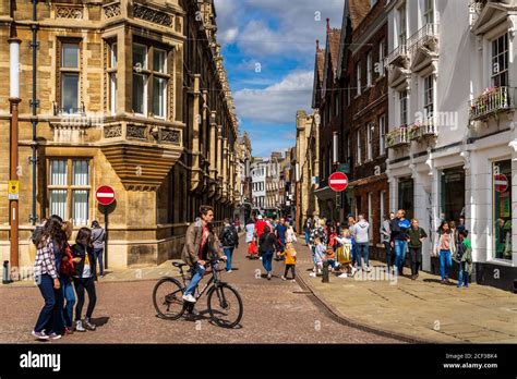 Cambridge City Centre, pedestrians and cyclists mix on Trinity Street in Central Cambridge UK ...