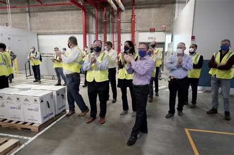 Pfizer Employees Clap After Line Workers Finished Packing Boxes Containing The Pfizer BioNTech ...