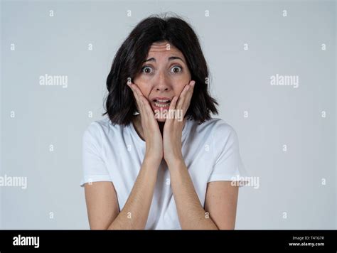 Close up of latin woman with frightened eyes, shocked making fear ...