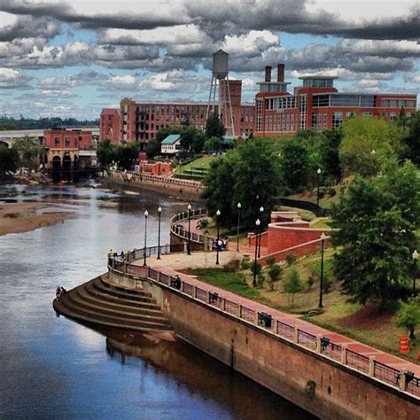 a river running through a city with tall buildings on both sides and ...