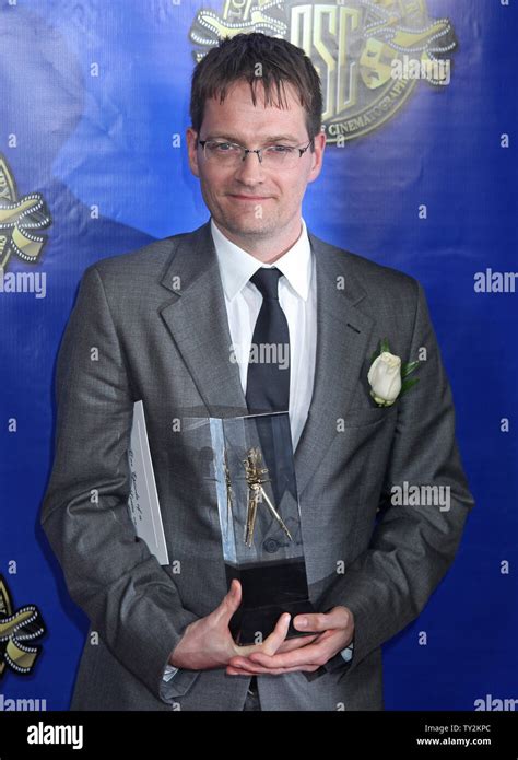 Cinematographer Jonathan Freeman arrives backstage after receiving the ...