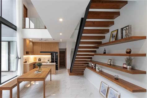 Double story house open interior with wood staircase