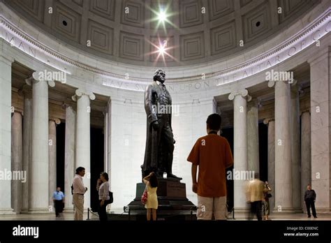 USA, Washington, District of Columbia, Tourists surround statue inside ...