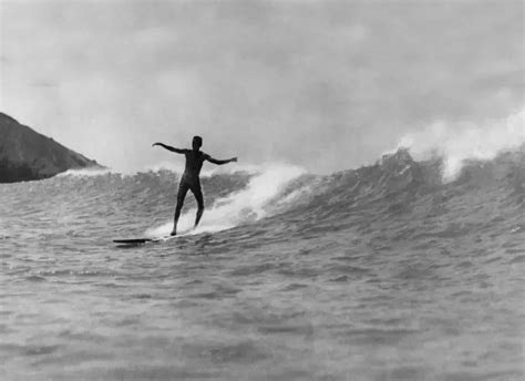 equator - A surfer rides a large wave in Honolulu, Hawaii,...