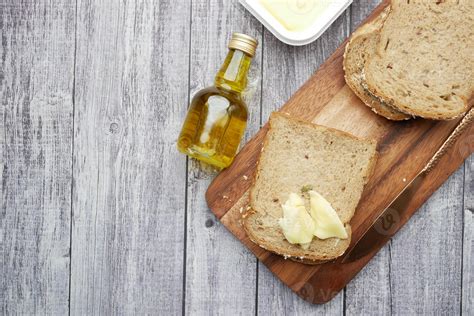 Slice of butter and whole meal bread on chopping board 3277243 Stock Photo at Vecteezy