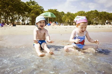 Children playing in water at beach stock photo