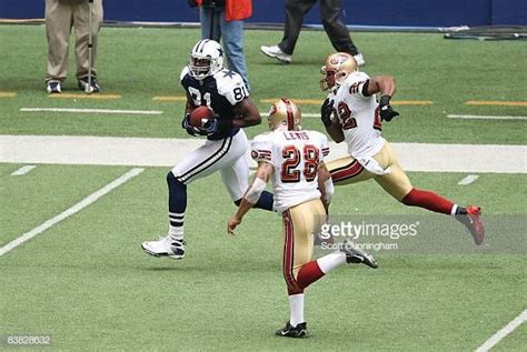 Terrell Owens of the Dallas Cowboys runs with a catch for a touchdown ...