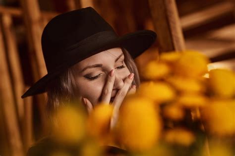 Premium Photo | Portrait of a laughing woman girl with a bouquet of yellow flowers the lady in ...