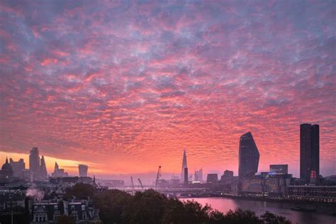 Epic sunrise over London city skyline with stunning sky formations over iconic landmarks - Stock ...