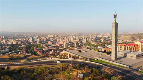 Aerial static wide Yerevan city center panorama view from cascade complex on sunrise in summer ...