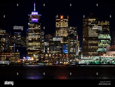 Vancouver Canada skyline on the waterfront at night. Harbour Centre and ...