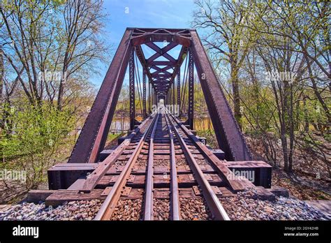 Close up on train tracks of steel bridge over water Stock Photo - Alamy