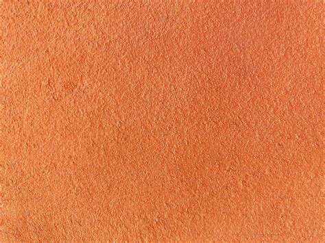 Seamless texture of orange cement wall a rough surface, with space for ...