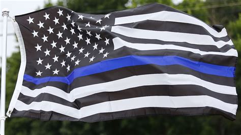 Thin blue line flag lowered during National Police Week in Oconomowoc