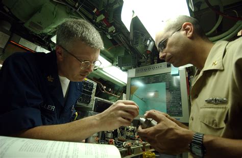 File:US Navy 051025-N-9288T-112 Electronics Technician 1st Class Jay Miller, left, and Chief ...