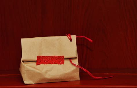 Royalty-Free photo: Beige paper bag on red surface | PickPik