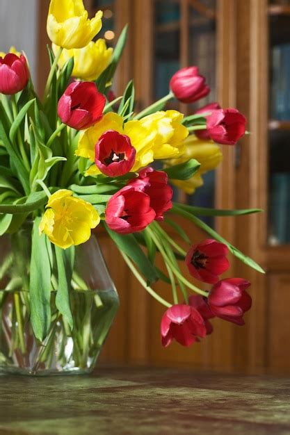 Premium Photo | Tulips on a table in a living room