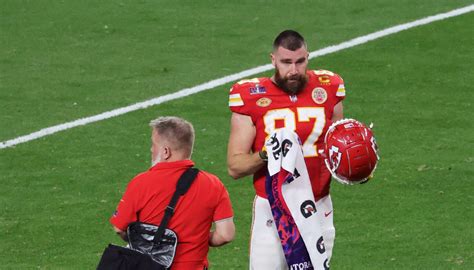 Chiefs TE Travis Kelce bumps coach Andy Reid on sideline during Super Bowl