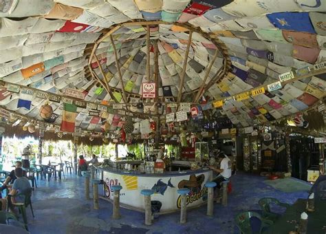 Coconut Bar, Cozumel, Mexico. Decorated with t-shirts from travelers from around the world ...