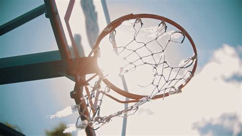 A basketball training outside. Throwing a ball in a basketball hoop. The ball gets right in ...