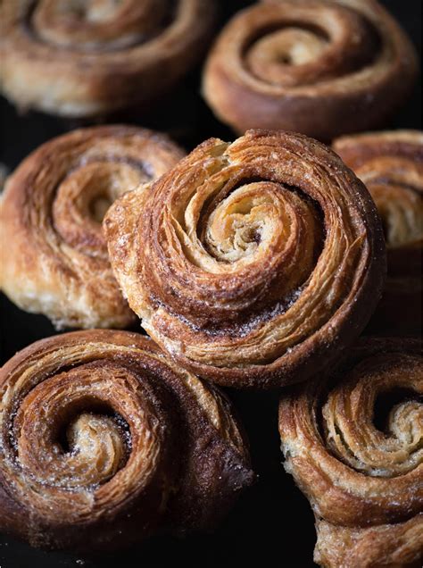 cinnamon rolls are stacked on top of each other and ready to be baked in the oven