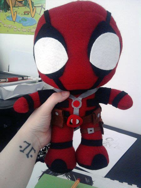 someone is holding up a deadpool stuffed animal