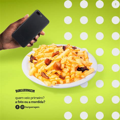 a person holding a cell phone over a plate of macaroni and cheese on a green background