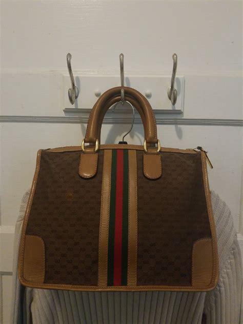 USED AUTHENTIC VINTAGE GUCCI HANDBAG. It has a spot on the front seen in picture 2. This ...