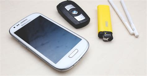 Phone, car key, lighter & cigarettes · Free Stock Photo