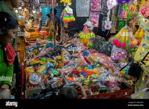 Asian people are looking at plastic toys made in China at a trade show ...