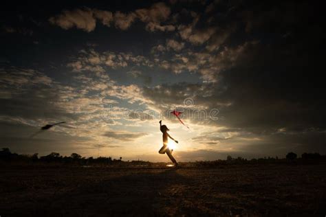 Silhouette of Children Flying a Kite on Sunset Stock Image - Image of ...