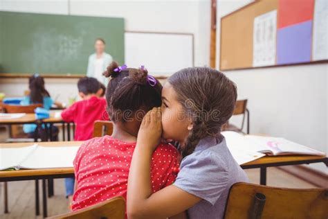 Child whispering at school stock photo. Image of gossiping - 6181822