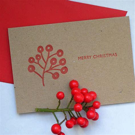 a christmas card with red berries on it next to a small tree branch and the words merry christmas