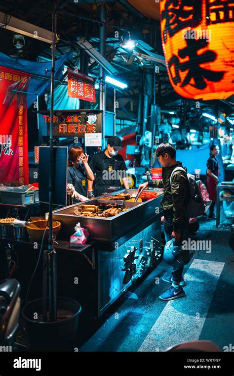 Taichung, Taiwan: A boy is buying a night snack at a street food stall ...