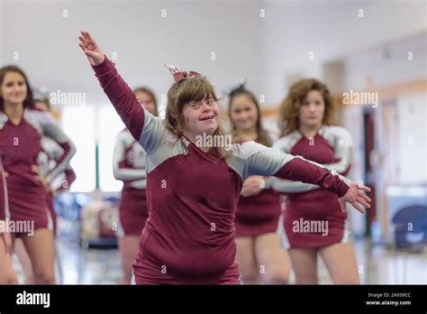 Cheerleader with Down Syndrome cheering with her friends Stock Photo ...