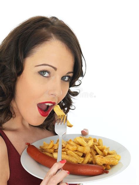 Young Woman Eating Saveloy Sausage with Chips Stock Image - Image of dark, holding: 51512295