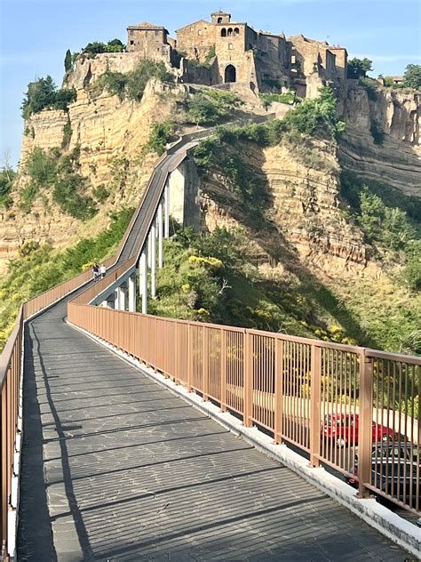 cityscape and pedestrian bridge of Civita di bagnoregio | City travel, Countries to visit ...