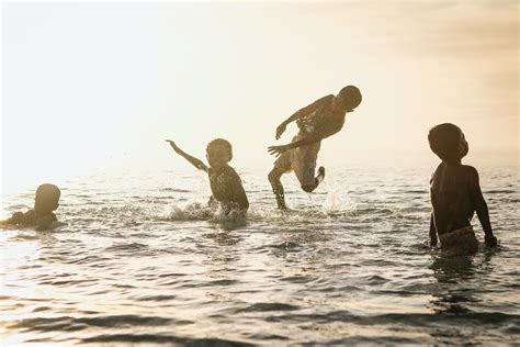 4 Person Playing in Ocean during Daytime · Free Stock Photo