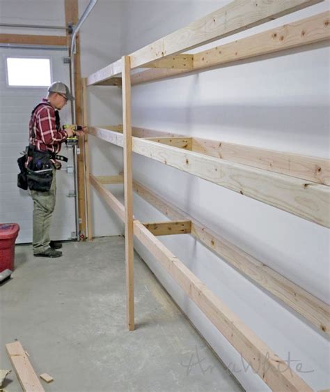 a man working on some shelves in a garage