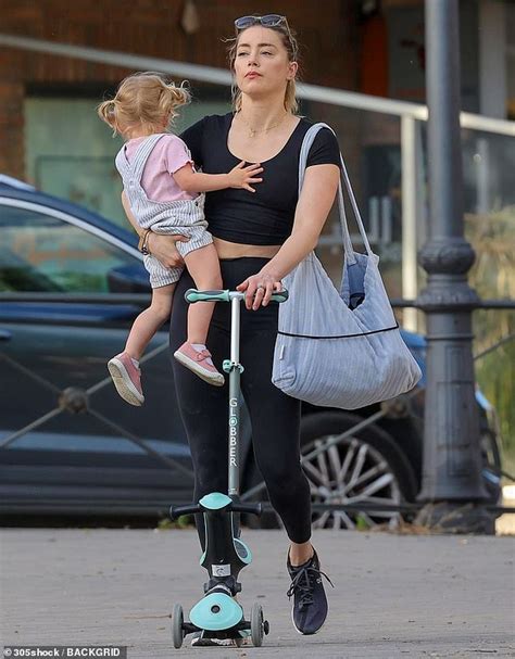 Amber Heard pushes a scooter as she takes her daughter Oonagh to a park ...