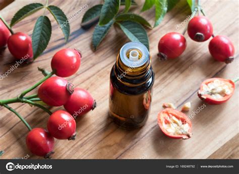 A bottle of rose hip seed oil on a wooden table Stock Photo by ...