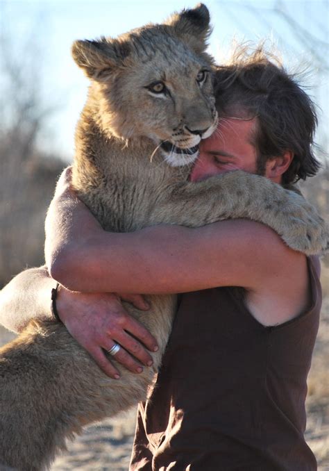 Hugging a Lion in Botswana | Lioness, Animals friends, Men with cats