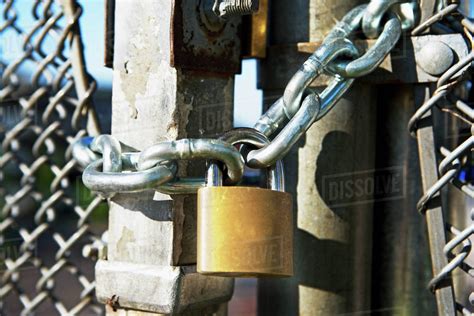 Close up of padlock on gate - Stock Photo - Dissolve